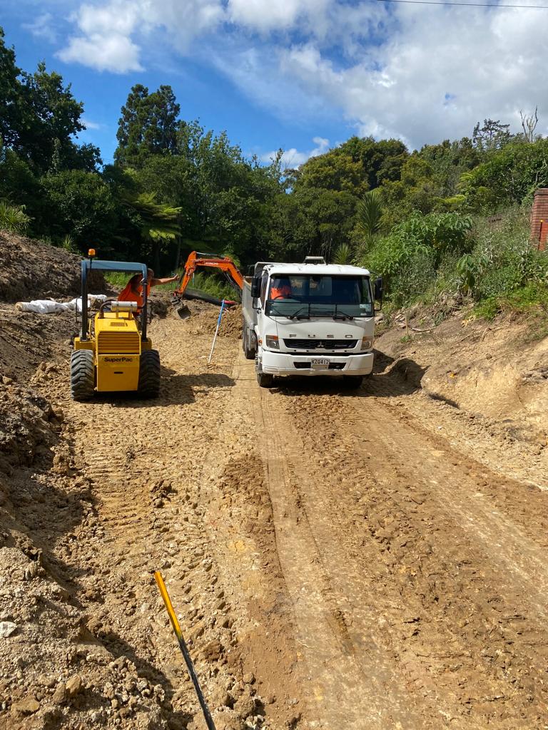 Civil site preparation with compactor and truck